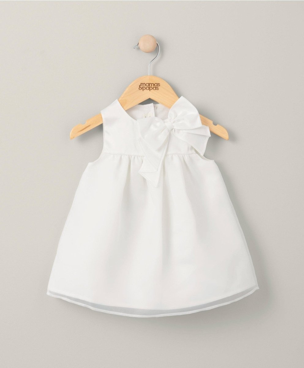 White organza bow dress on hanger, sleeveless with bow collar and gathered waist