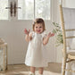White organza bow dress, sleeveless with bow shoulder detail and ruffled neckline