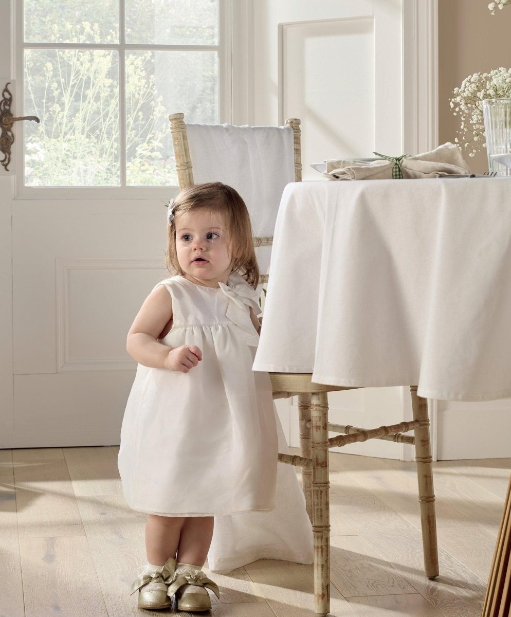 White organza bow dress, front view with ruffle yoke and bow at neckline