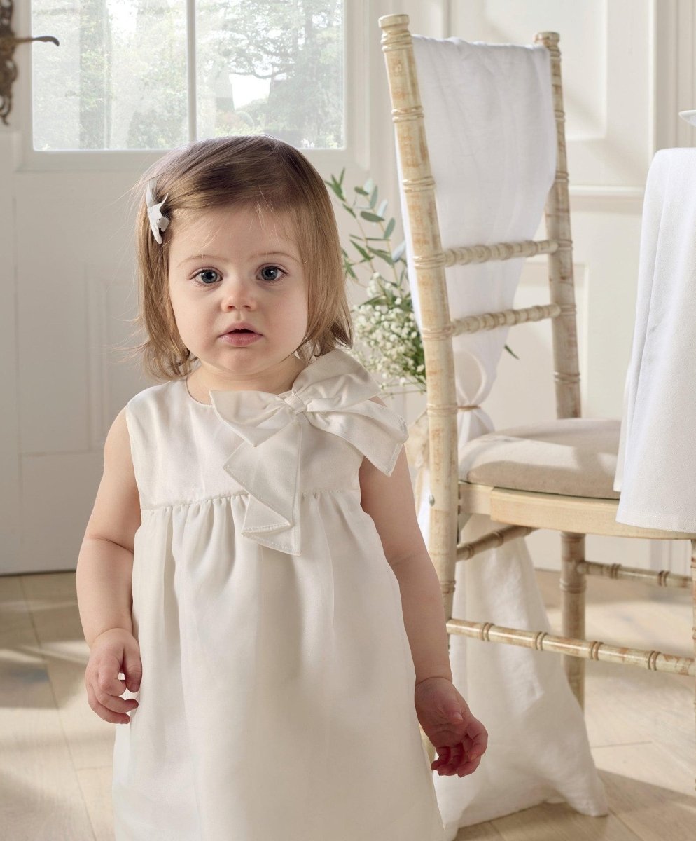White organza bow dress, sleeveless with pleated bodice and gathered skirt