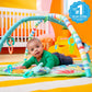Green activity gym play mat with colorful arch and hanging animal toys