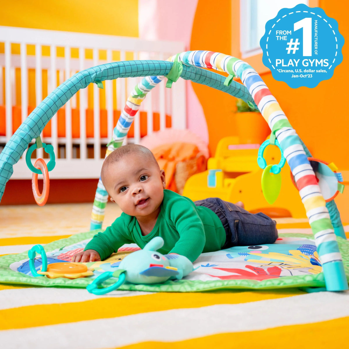 Green activity gym play mat with colorful arch and hanging animal toys