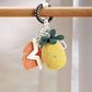 Pineapple teething toy hanging on bar: plush pineapple, fabric star, orange leaves on ring