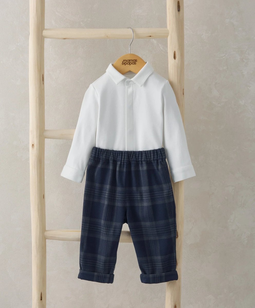 White button-front bodysuit and navy plaid trousers set