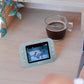 Light blue roll video monitor with touchscreen displaying a sleeping baby on screen