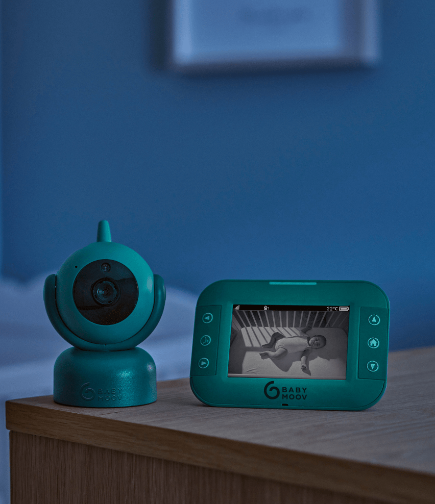 Mint green baby video monitor showing live view on screen with camera unit