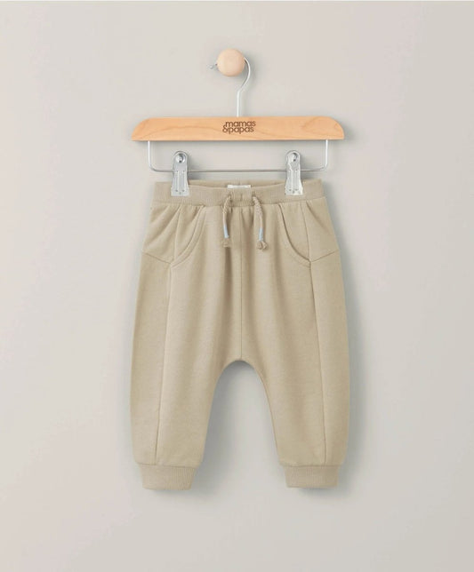 Beige fleece jogger pants with drawstring waist and side pockets, elastic cuffs.