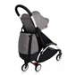Stroller bag in grey and black attached to a compact stroller with straps