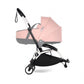 Stroller with pink carrycot and black seat, front swivel wheel and handlebar