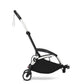 Black stroller frame with canopy, black seat, and front swivel wheels