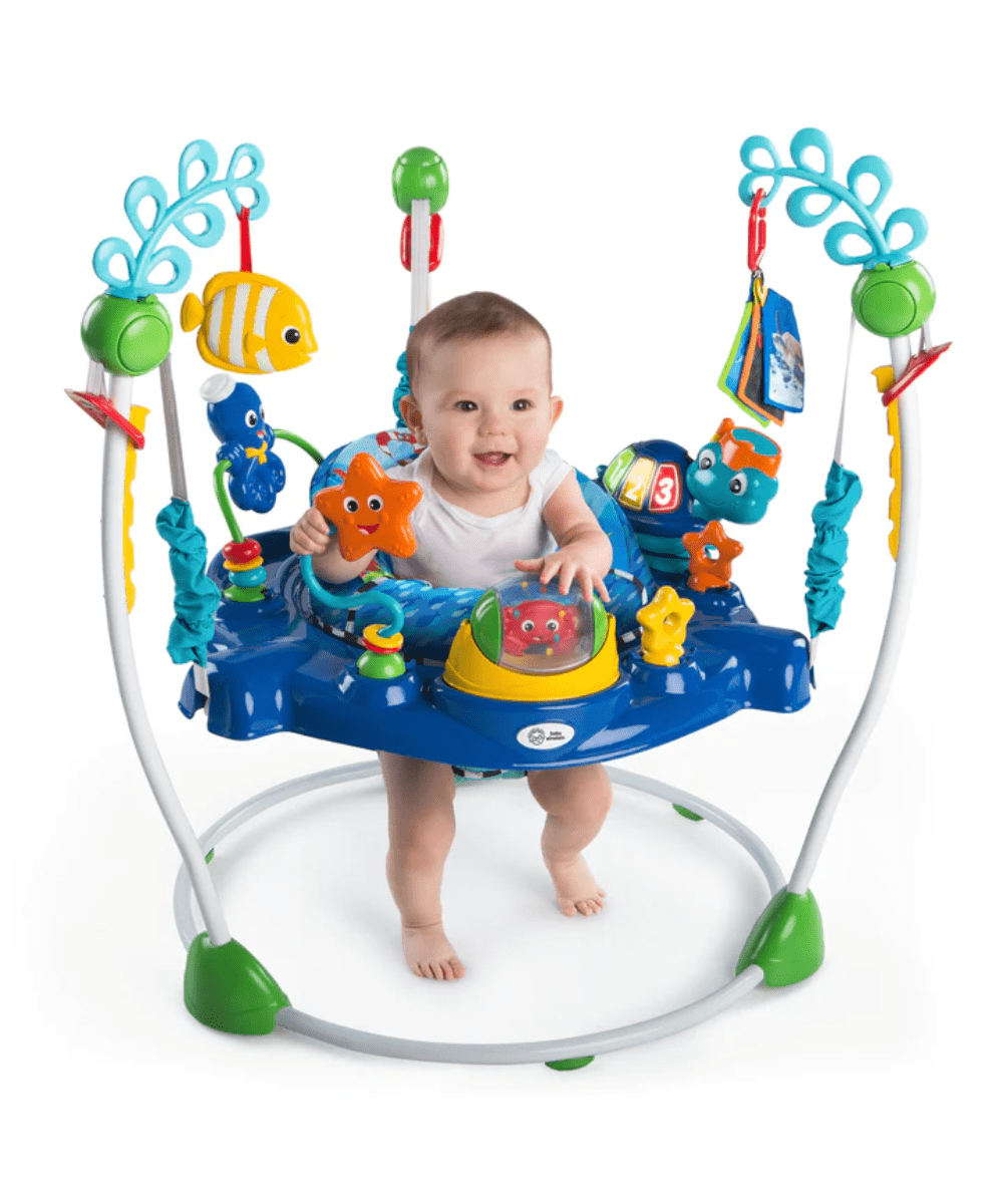 Neptune’s Ocean jumper with baby standing inside blue play seat and dangling toys