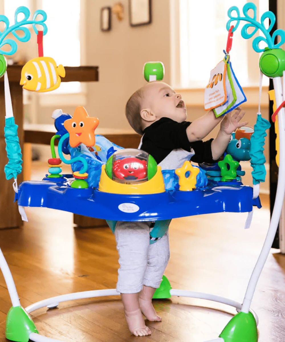 Neptune’s Ocean jumper with toddler touching sea-themed toys while standing
