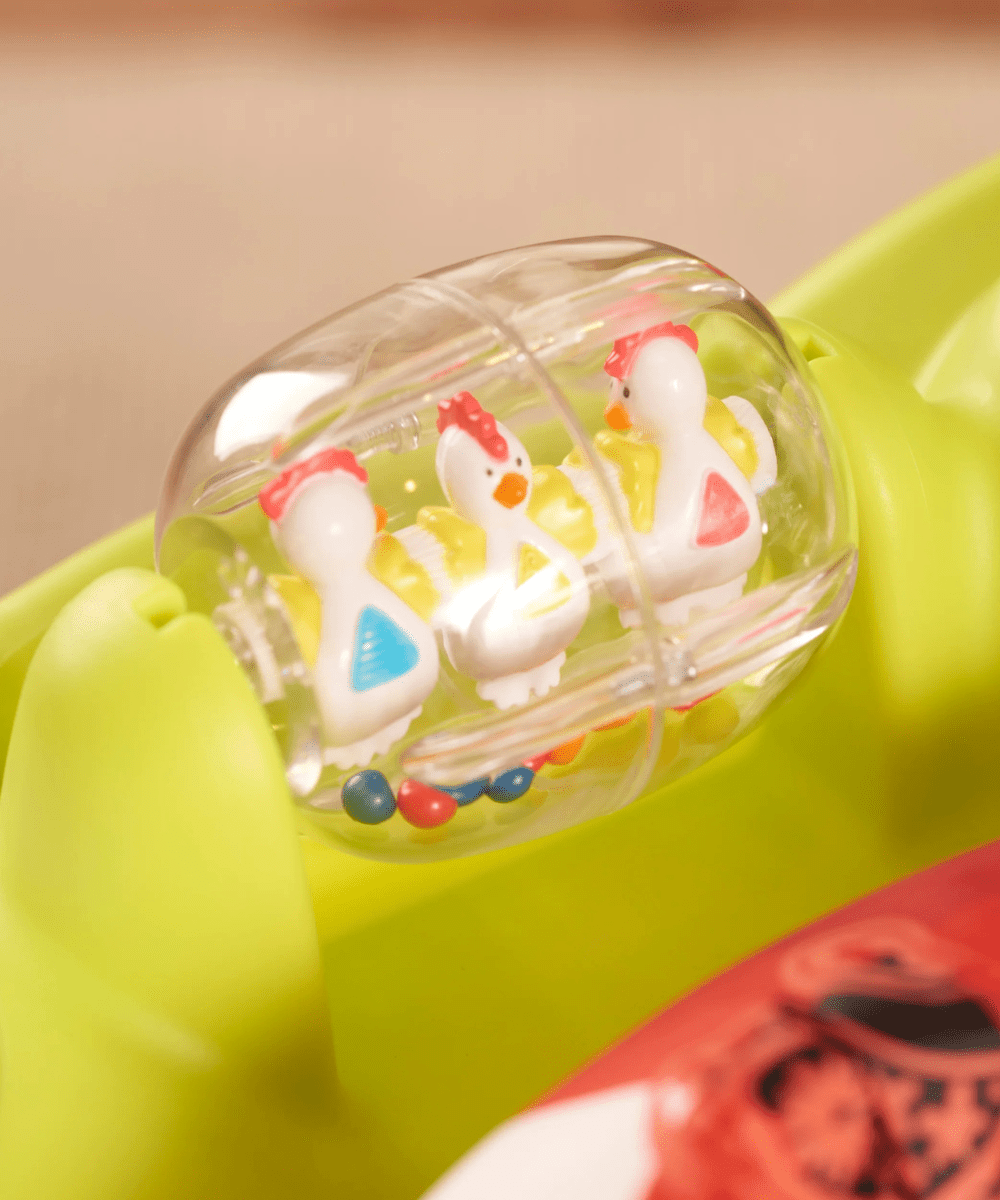 Clear rolling drum toy on lime green activity saucer