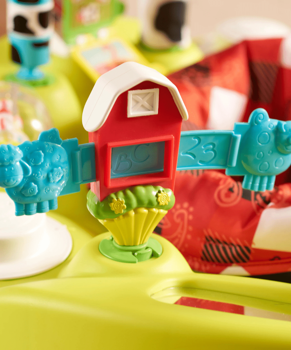 Red barn-shaped activity panel with window detail on yellow saucer