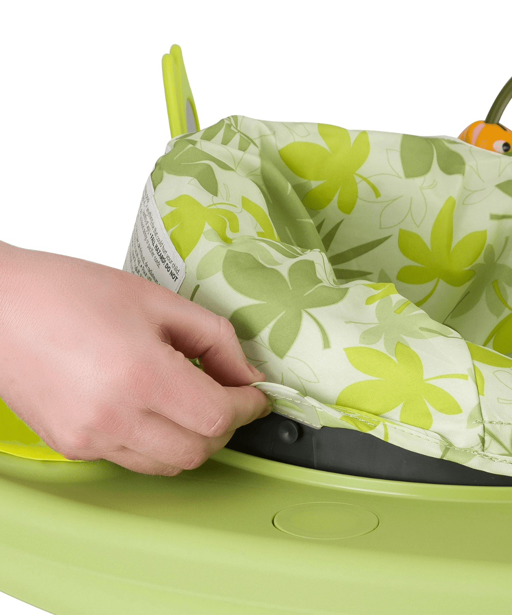 Green and white patterned fabric seat with hand pressing a toy control