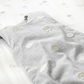 Grey baby sheet set with cloud and rainbow pattern, folded for display