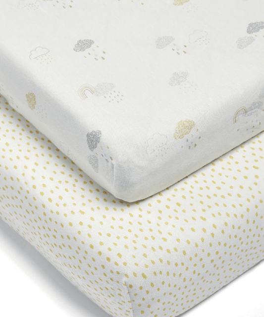 White baby sheet with small cloud and rainbow prints, neatly folded at corner